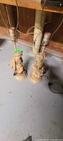 Full view of both lamps showing figurine bases, sockets, cords