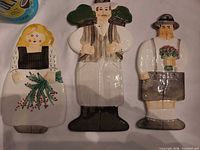 All three flat glass folk figure plaques