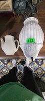 Pitcher pocket and ribbed shade side by side on table