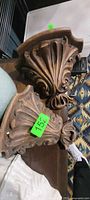 Top view of both carved wooden wall shelves showing acanthus design and finish