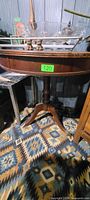 Side view showing table shape, pedestal column and base