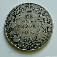 Reverse side of 1919 Canada 50-cent coin showing denomination, wreath, crown, date