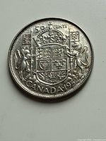 Reverse of 1952 Canadian 50 cent coin showing coat of arms