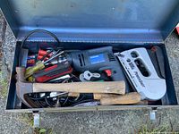 Open toolbox with drill, staple gun, hammer, screwdrivers visible