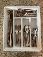 Flatware arranged in tray showing quantity and types