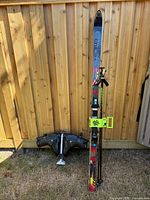 Front view showing skis, poles, boots, lock