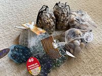 Group shot of all river stones, glass gems and marbles in mesh and drawstring bags