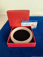 Bangle in red box with authenticity card