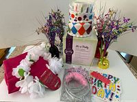 Group shot showing Scentsy warmer, tablecloth (folded), balloon weights, lei, tiara pack, birthday sign