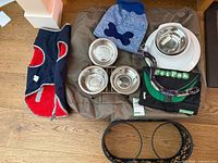All items laid out including bed, bowls, leash, sweater, jacket