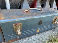 closed blue metal toolbox with rust and latches