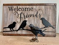 Wall plaque and bird figurine together