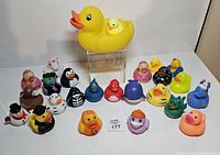 Group view of all rubber ducks including large mother duck and assorted themed small ducks