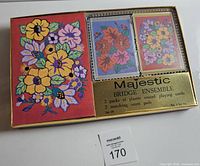 Front view of boxed Majestic Bridge Ensemble showing floral design cards and score pads