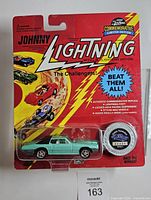 Front view of sealed Johnny Lightning Custom Thunderbird package with car and coin visible