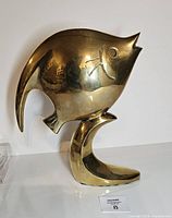 Left-side view of polished brass fish sculpture