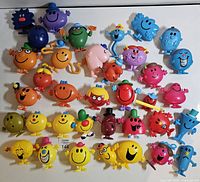 Full group of colourful plastic Mr. Men & Little Miss figurines laid out