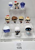 Overall lot showing 11 mini Funko figures on clear risers