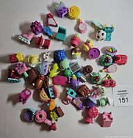 Wide shot of all Shopkins laid out on white background