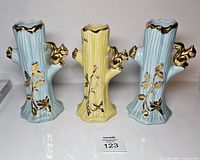 Front view of three pastel vases showing color, shape and gold accents
