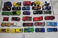 Overall view of 28 die-cast vehicles arranged on white background