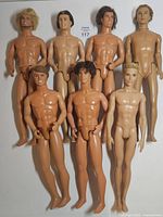 Group shot of all seven nude Ken dolls standing