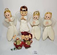 Group view of four angel carolers and two mouse carolers