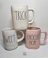 Front view of all three mugs showing slogans