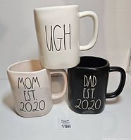 Front view of all three mugs showing text and colors