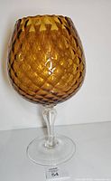 Full view of amber optic brandy snifter front