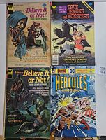 All four comics laid out—two Ripley’s True Ghost Stories, one Ripley’s True Demons and Monsters, one DC Hercules Unbound