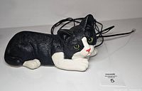 Top view of black and white cat telephone with line cord visible