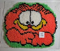 Front view of completed latch hook Garfield rug panel