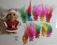 Group shot: Santa troll and ten translucent mini trolls