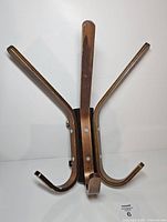 Front view showing three visible wooden arms attached to metal backing
