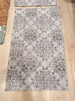 Both rugs laid out flat showing full pattern and size comparison