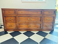 Front view showing 9 drawers and brass-tone handles
