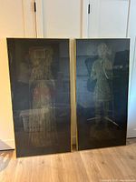 Both framed brass rubbings side by side