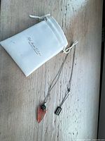 Necklace, branded pouch