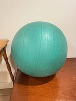 Full view of teal stability ball on table