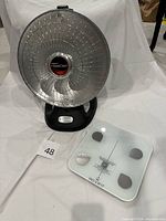 Presto HeatDish heater front view beside Inevifit scale