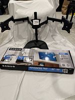 Triple monitor stand assembled with Sanus wall mount retail box