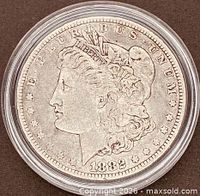 Obverse of 1882 Morgan dollar in capsule showing Liberty head and date