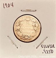 Coin in holder front view showing reverse wreath design