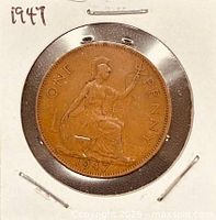 Reverse of 1947 one-penny coin in flip showing Britannia design