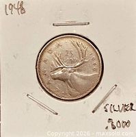 Reverse of 1948 Canada 25-cent coin showing caribou and date