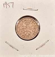 Reverse side showing crowned rose with thistle, shamrock, leek and inscription SIX PENCE 1957