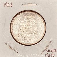 Full view of the coin in holder, date and silver note visible