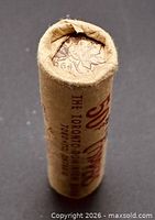 Side view of sealed coin roll showing maple leaf end