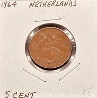 Coin in holder showing reverse with 5 CENT and date